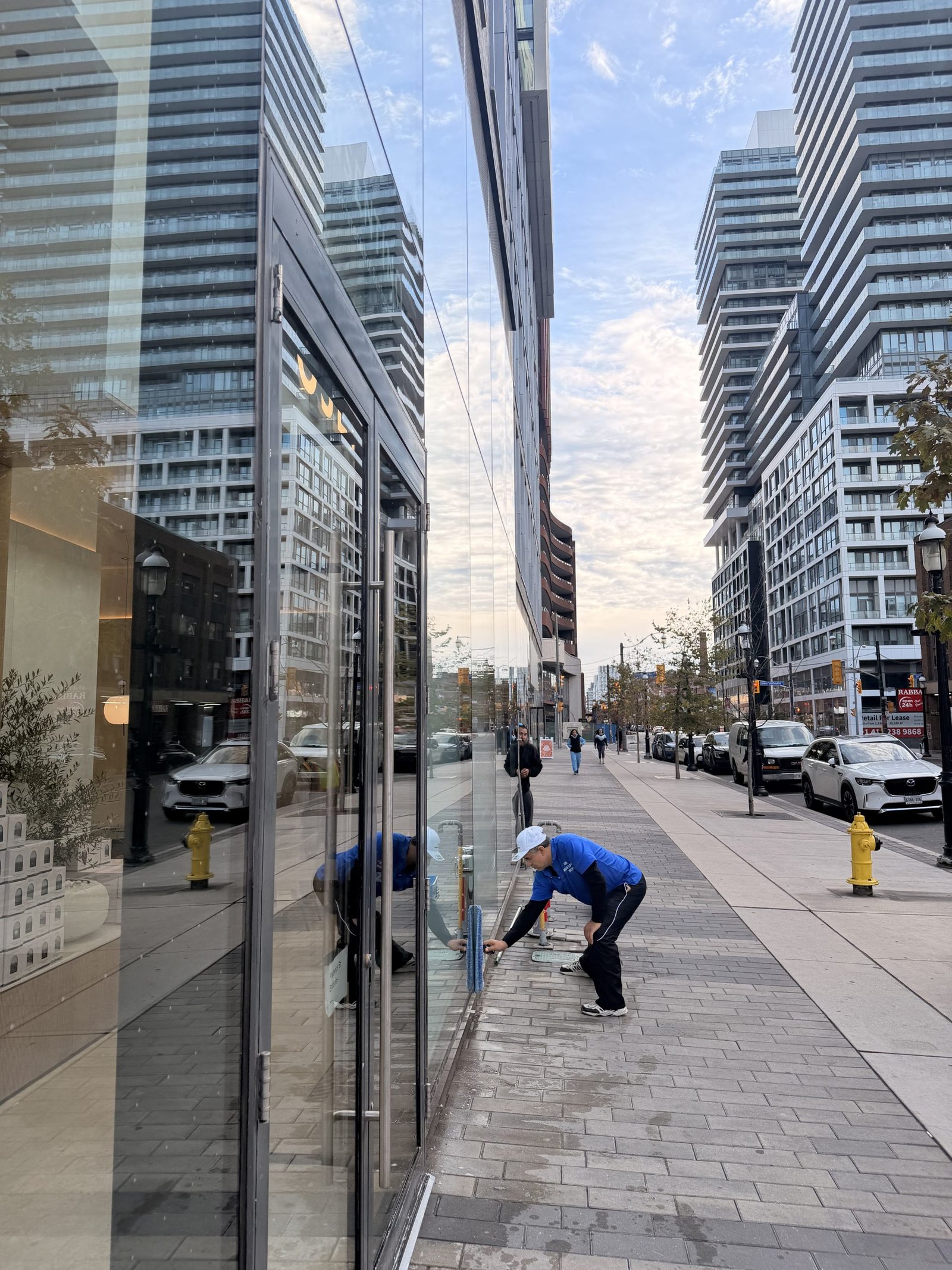 iShine technician cleaning a downtown Toronto storefront