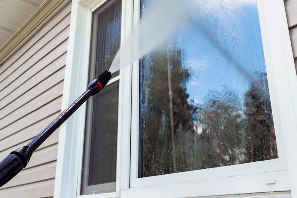 Professional pressure washing of an exterior surface
